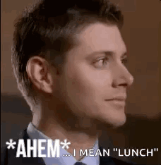 Man In Suit And Tie Saying Ahem GIF