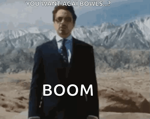 Man in Suit and Tie Saying Boom in Desert Mountains