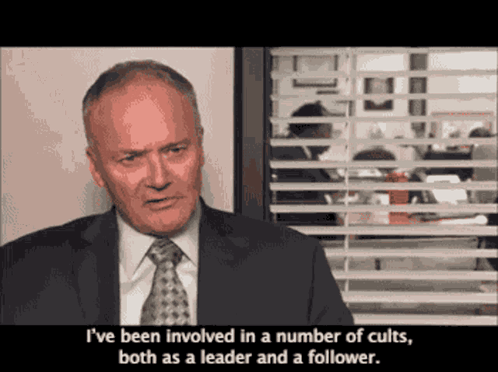Man in Suit and Tie Saying Cults