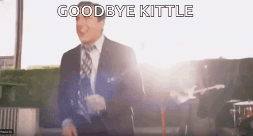 Man In Suit And Tie Saying Goodbye Kittle In Front Of Guitar GIF