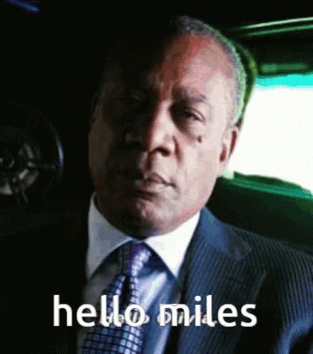 Man In Suit And Tie Saying Hello Miles GIF