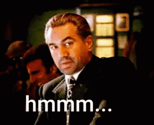 Man In Suit And Tie Saying Hmm GIF