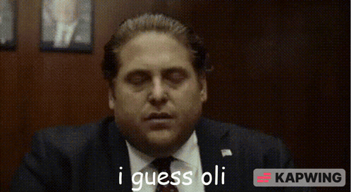 Man in Suit and Tie Saying I Guess Oli