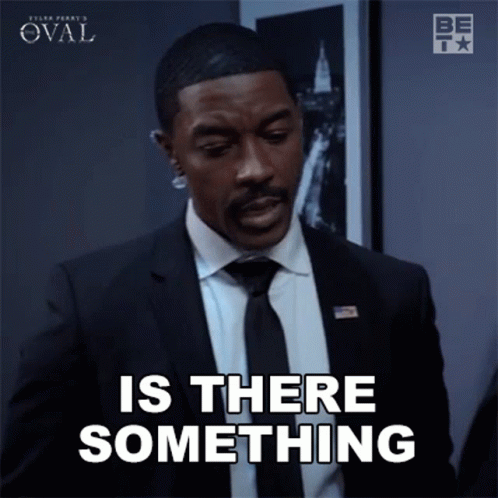 Man in Suit and Tie Saying Is There Something