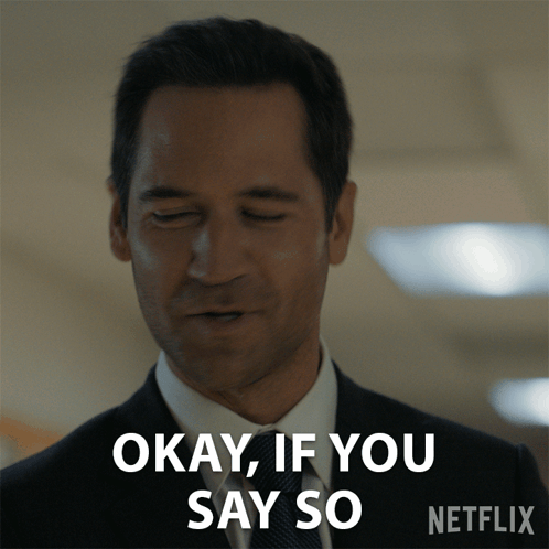 Man in Suit and Tie Saying Okay
