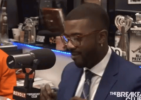 Man in Suit and Tie Saying Revolt Breakfast Club