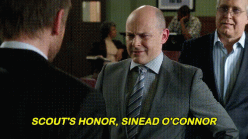 Man in Suit and Tie Saying Scout's Honor