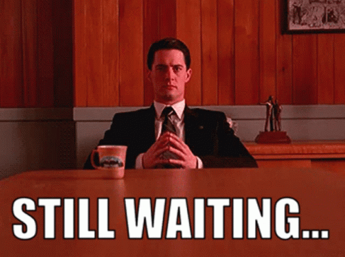 Man In Suit And Tie Saying Still Waiting GIF