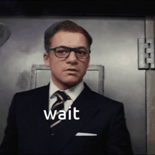 Man in Suit and Tie Saying Wait