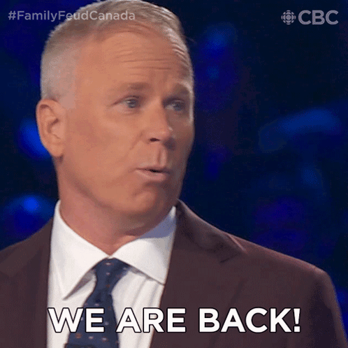 Man In Suit And Tie Saying We Are Back GIF