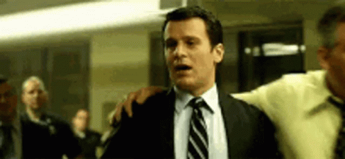 Man in Suit and Tie Saying Whaaaaat Into Microphone