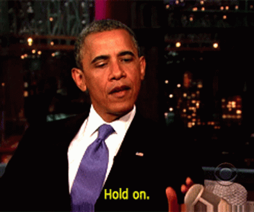Man In Suit And Tie Saying Yellow Hold On GIF