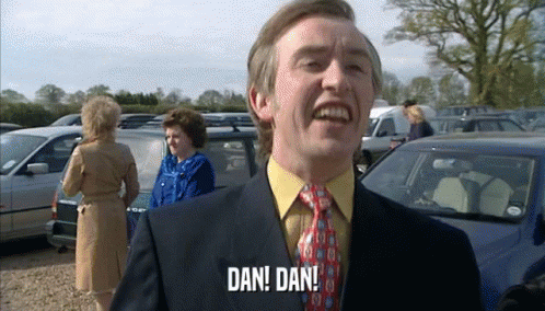 Man in Suit and Tie Says Dan Dan