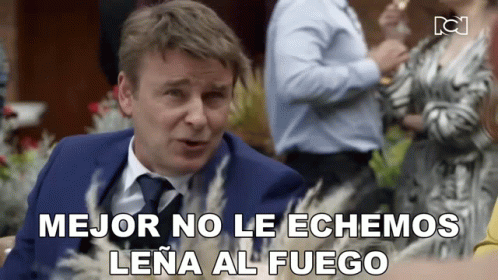 Man in Suit and Tie Says mejor no le echamos lena al fuego
