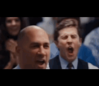 Man in Suit and Tie Screaming in Crowd