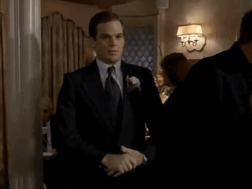 Man in Suit and Tie Screaming in Room