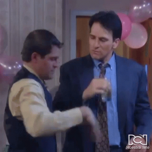 Man In Suit And Tie Shaking Hands With Man In Vest GIF