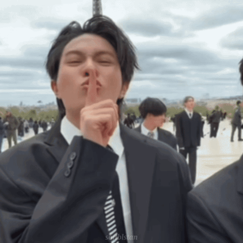 Man in Suit and Tie Shushing