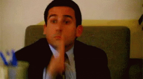 Man In Suit And Tie Shushing GIF