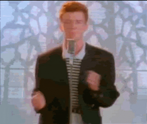 Man in Suit and Tie Singing into Microphone