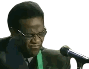Man in Suit and Tie Singing into Microphone