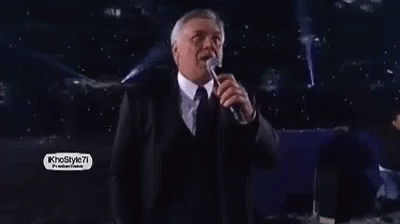 Man in Suit and Tie Singing into Microphone khostyle7