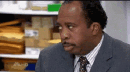 Man In Suit And Tie Sitting GIF