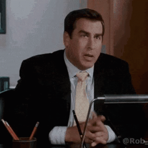 Man in Suit and Tie Sitting at Desk