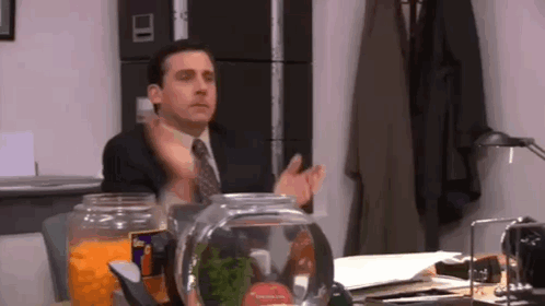 Man in Suit and Tie Sitting at Desk