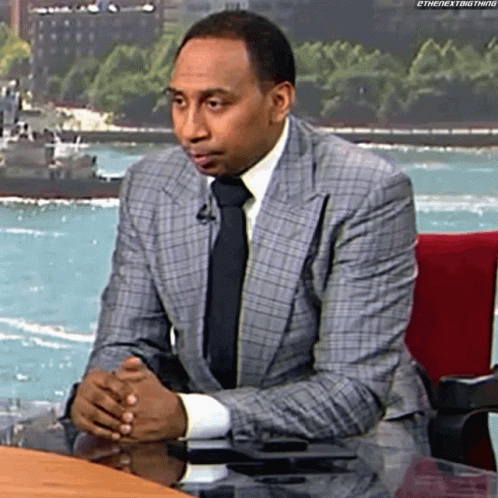 Man In Suit And Tie Sitting At Desk GIF