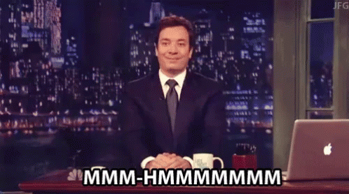 Man In Suit And Tie Sitting At Laptop Saying Hmm Hmmmm GIF
