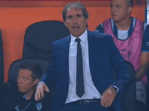 Man in Suit and Tie Sitting in Chair