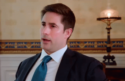 Man In Suit And Tie Sitting In Chair GIF