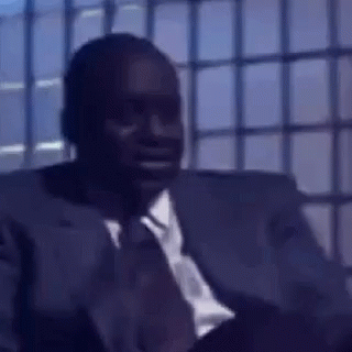 Man in Suit and Tie Sitting in Chair