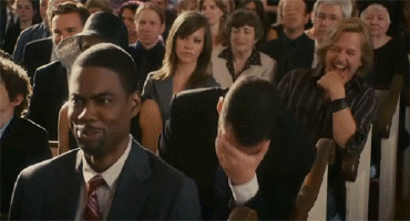 Man in Suit and Tie Sitting in Crowd