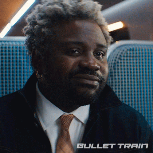 Man in Suit and Tie Sitting on Bullet Train
