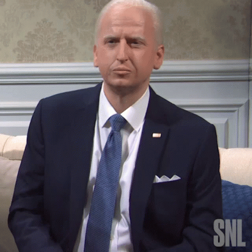 Man in Suit and Tie Sitting on Couch