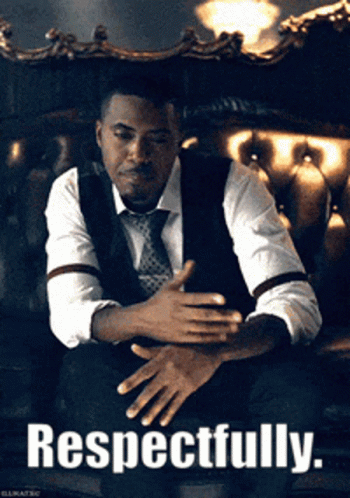 Man in Suit and Tie Sitting on Couch Respectfully