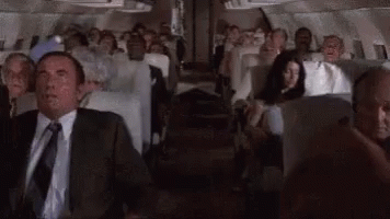 Man in Suit and Tie Sitting on Plane