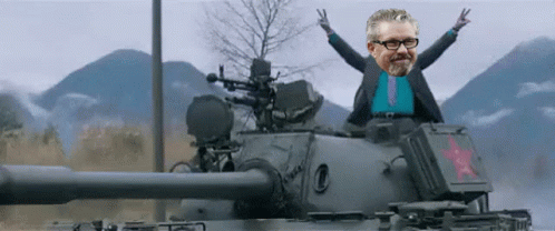Man in Suit and Tie Sitting on Tank