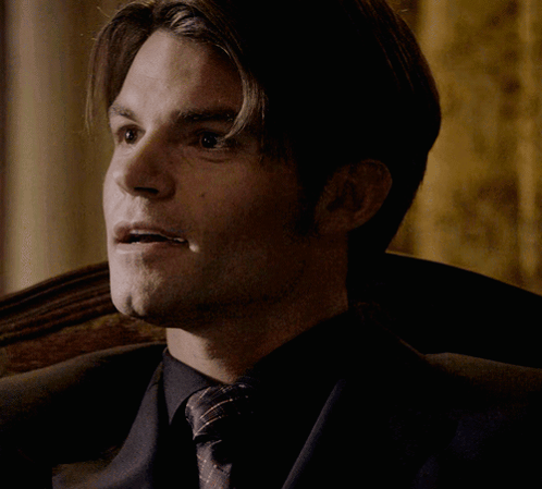 Man In Suit And Tie Sitting With Eyes Closed GIF