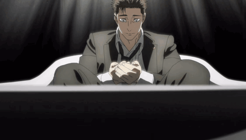 Man In Suit And Tie Sitting With Hands Folded GIF