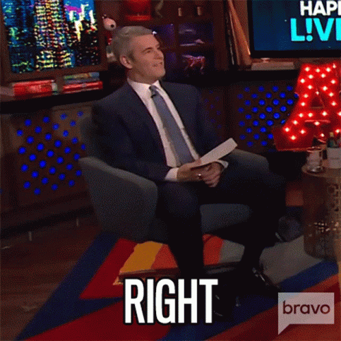 Man in Suit and Tie Sitting With Speech Bubble Saying Right
