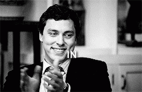 Man in Suit and Tie Smiling and Clapping