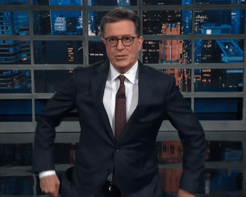 Man in Suit and Tie Smiling and Dancing