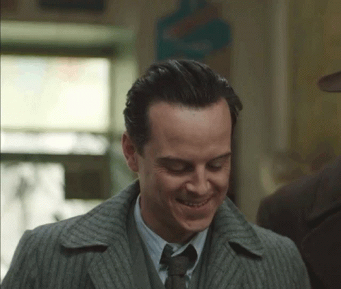 Man in Suit and Tie Smiling Down