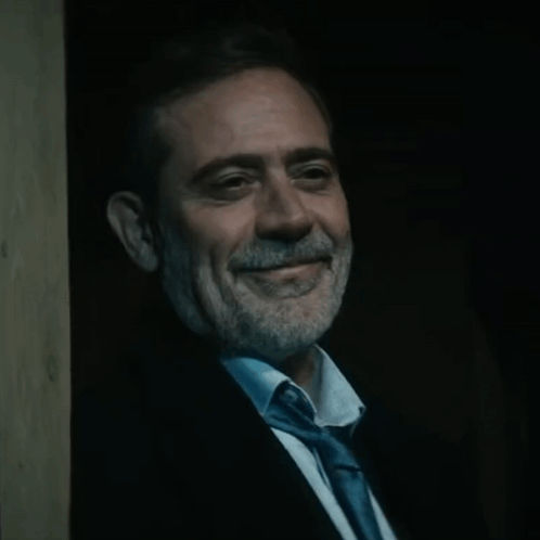 Man in Suit and Tie Smiling in Dark
