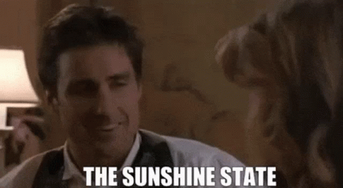 Man in Suit and Tie Smiling Talking to Woman The Sunshine State