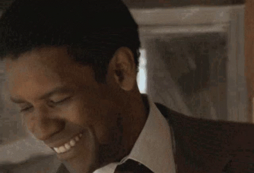 Man in Suit and Tie Smiling with Closed Eyes