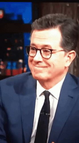 Man in Suit and Tie Smiling With Glasses